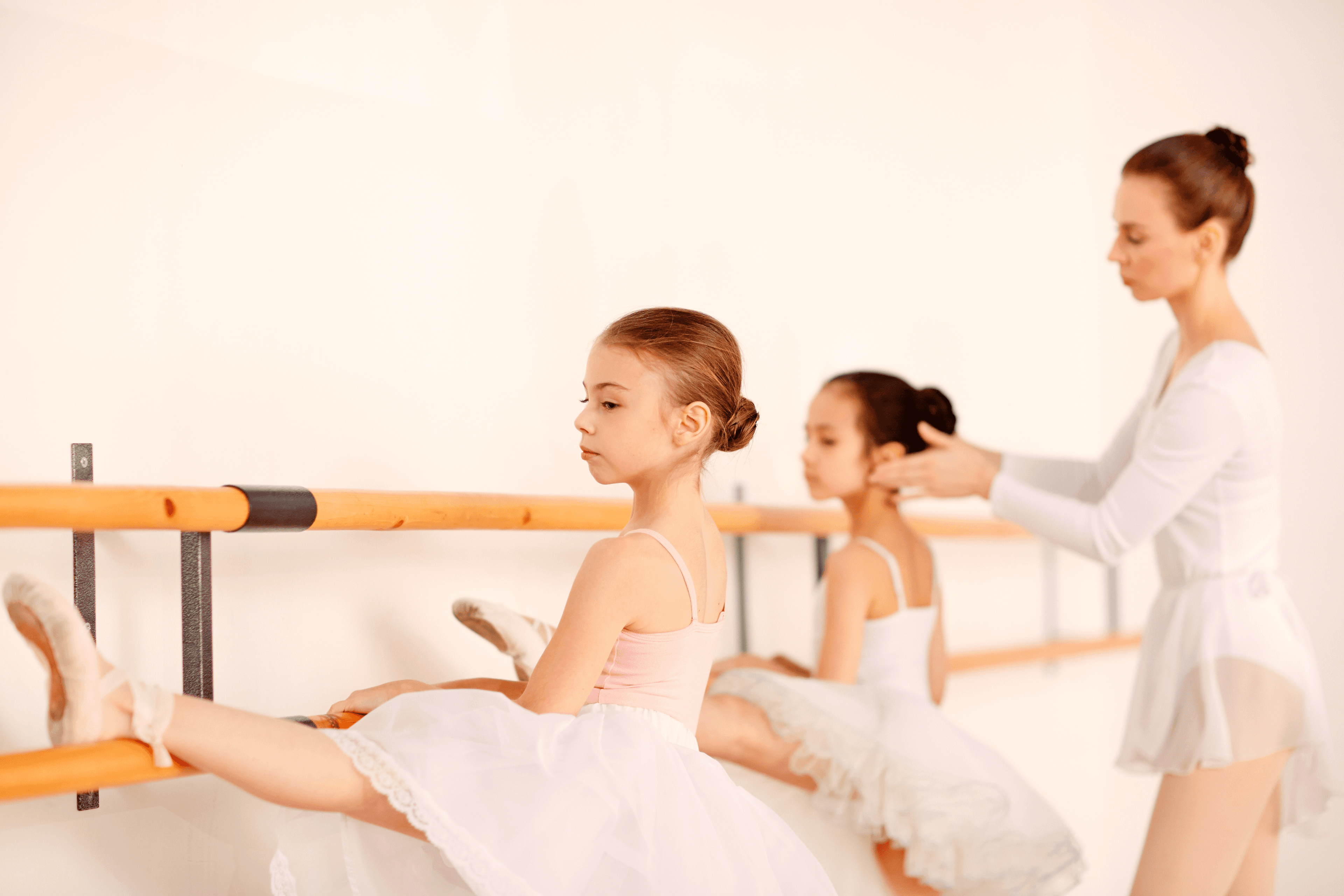 Young ballet students training at the barre