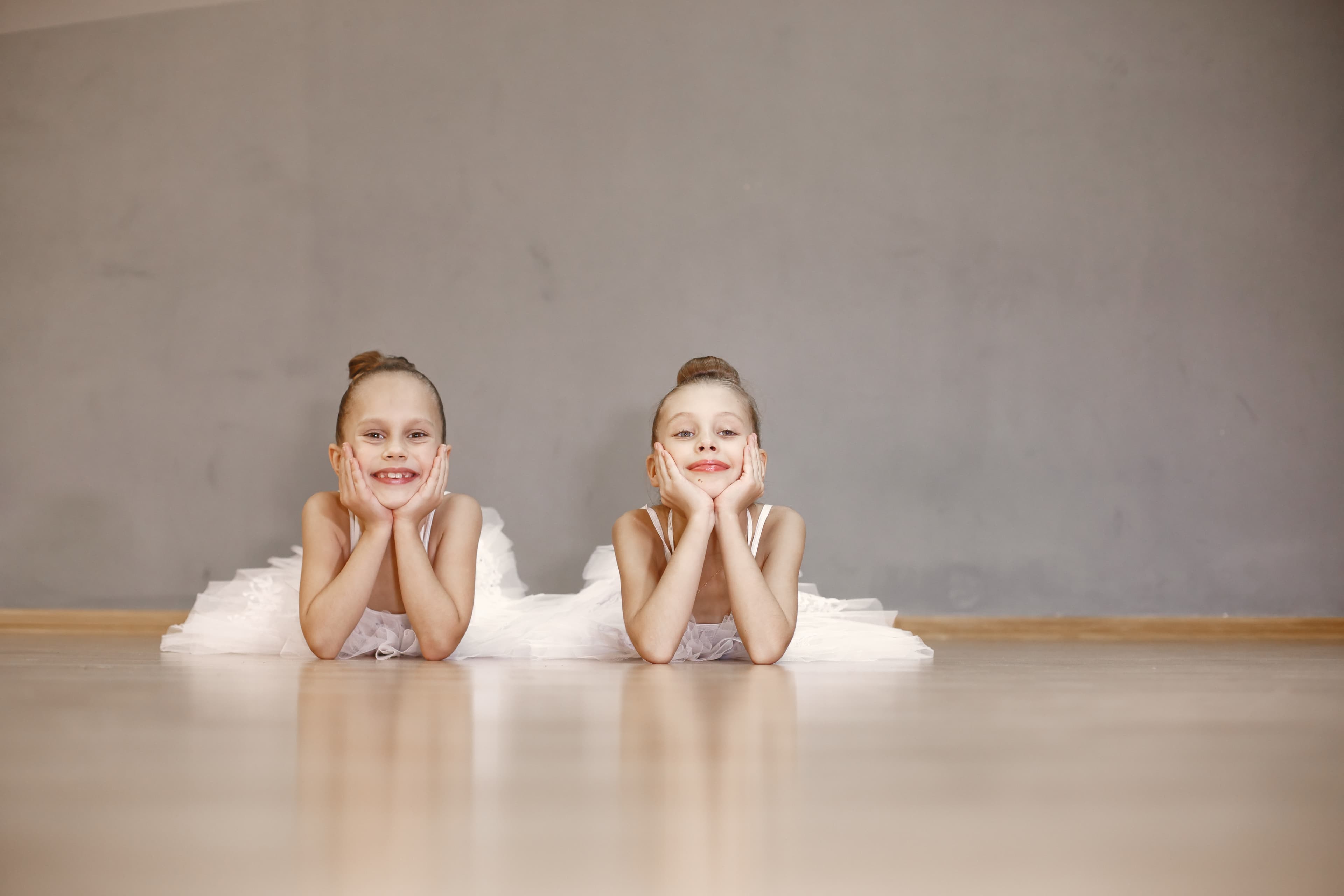 Two young ballet dancers smiling